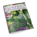 Titelbild der Zeitschrift „Garten & Wohnen Träume“, Ausgabe 3/2026. Im Vordergrund ein blühender Garten mit weißen und violetten Blumen, grünen Sträuchern und einer weißen Gartenbank; darüber Texte wie „Willkommen im Sommergarten“, „Köstliches mit Kirschen“, Hinweise auf Gartentouren, Blütensorten und elegante Interieurs. In der oberen linken Ecke ein rundes Foto eines Kirschkuchens.