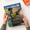 Titelbild des Gaming-Magazins „GameStar XL“ mit einer männlichen Person in Anzug, die eine Pistole hält, vor gelb-grauem Hintergrund. Aufschrift u. a.: „007 FIRST LIGHT“, „ASSASSIN’S CREED: BLACK FLAG RESYNCKED“, „FORZA HORIZON 6“ und Spielehinweise zu „CYCLE“, „PARADISE KILLER“ und „VERNE“. Blaue Kopfzeile mit weißem Logo „GameStar XL“, gelber Rand mit Texten und sichtbarer Barcode unten rechts.