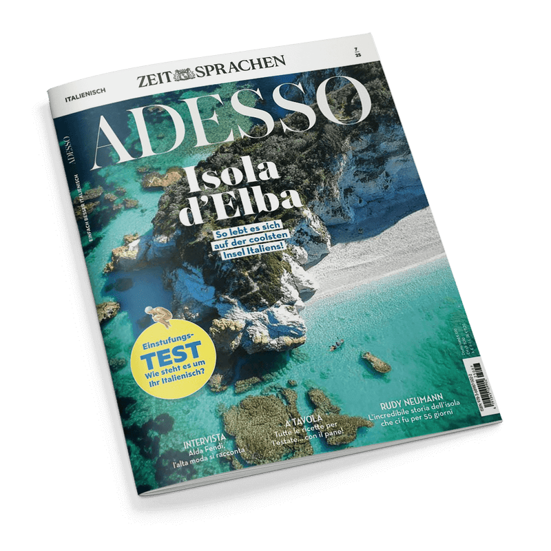 Magazin-Cover: ZEIT SPRACHEN ADESSO, malerische Luftaufnahme einer Küste mit türkisblauem Wasser und Felsen. Schlagzeile: Isola d'Elba – So lebt es sich auf der coolsten Insel Italiens!