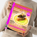 Weibliche Person in beigefarbenem Strickpullover hält eine schräg ausgerichtete Zeitschrift vor hellem Hintergrund. Das orangefarbene Cover trägt den Titel „FEINSCHMECKER“ sowie die Texte „Bodensee in Bestform“, „20 Top-Adressen“, „Portugals Genuss-Oasen“, „Neue Küchenwelten“ und „Junges Gemüse“; abgebildet ist ein angerichtetes Fischgericht mit Kaviar, grüner Sauce und Blüten.