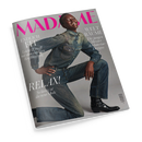 Schräg fotografiertes Cover der Zeitschrift „MADAME“ vor schwarzem Hintergrund. Eine männliche Person in blauem Denim-Hemd und Jeans sitzt auf grauem Grund und trägt schwarze Stiefeletten; sichtbare Texte: „ENDLICH FIT“, „Leicht & straff mit dem richtigen Krafttraining“, „WELT RÄUME“, „Die jungen Meister des Interior-Designs“ und „RELAX. So lässig ist die neue Mode“.