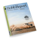 Cover des Robb Report Magazins mit einem futuristischen Auto, das Staub in einer Wüstenlandschaft aufwirbelt, und der Schlagzeile WER BREMST, VERLIERT.