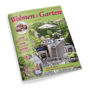 Magazincover Wohnen & Garten Juni 2025 mit gedecktem Tisch in einem blühenden Garten und der Schlagzeile Willkommen im Sommersalon.